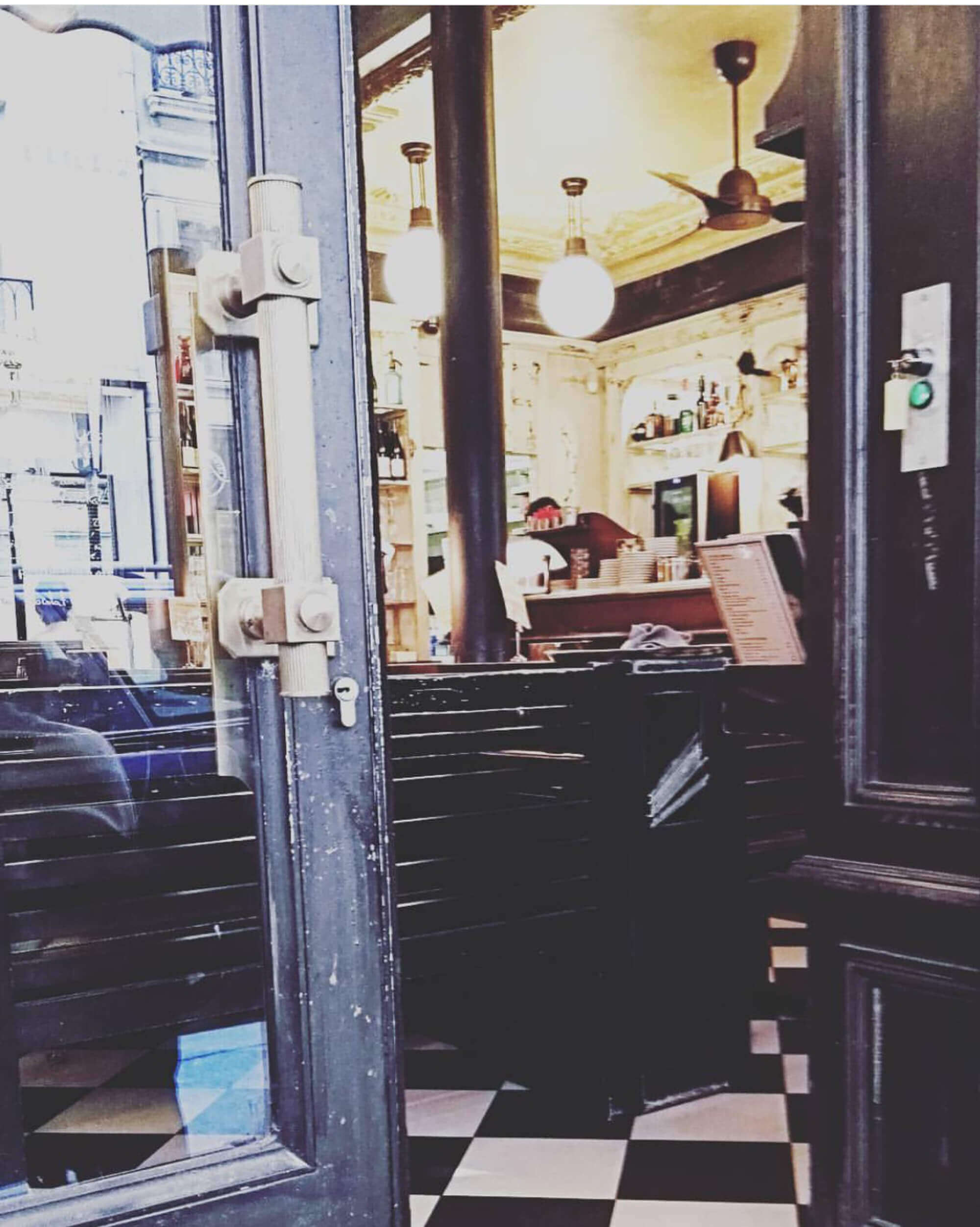 Blick auf und in Eingangstür eines Cafés in Paris.